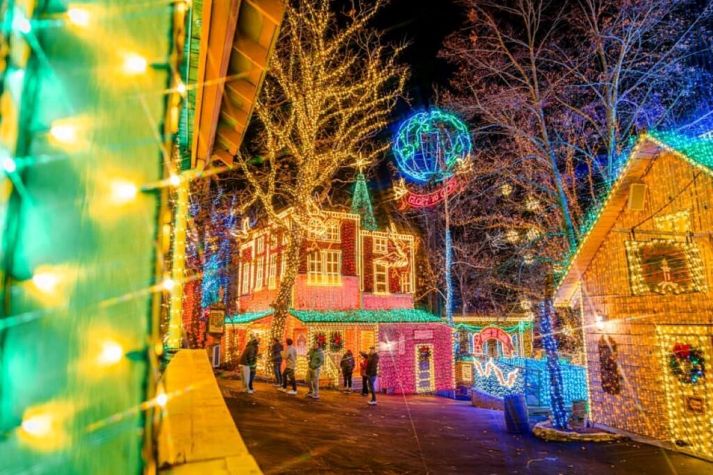 Colorful Christmas lights cover the buildings and trees at Silver Dollar CIty